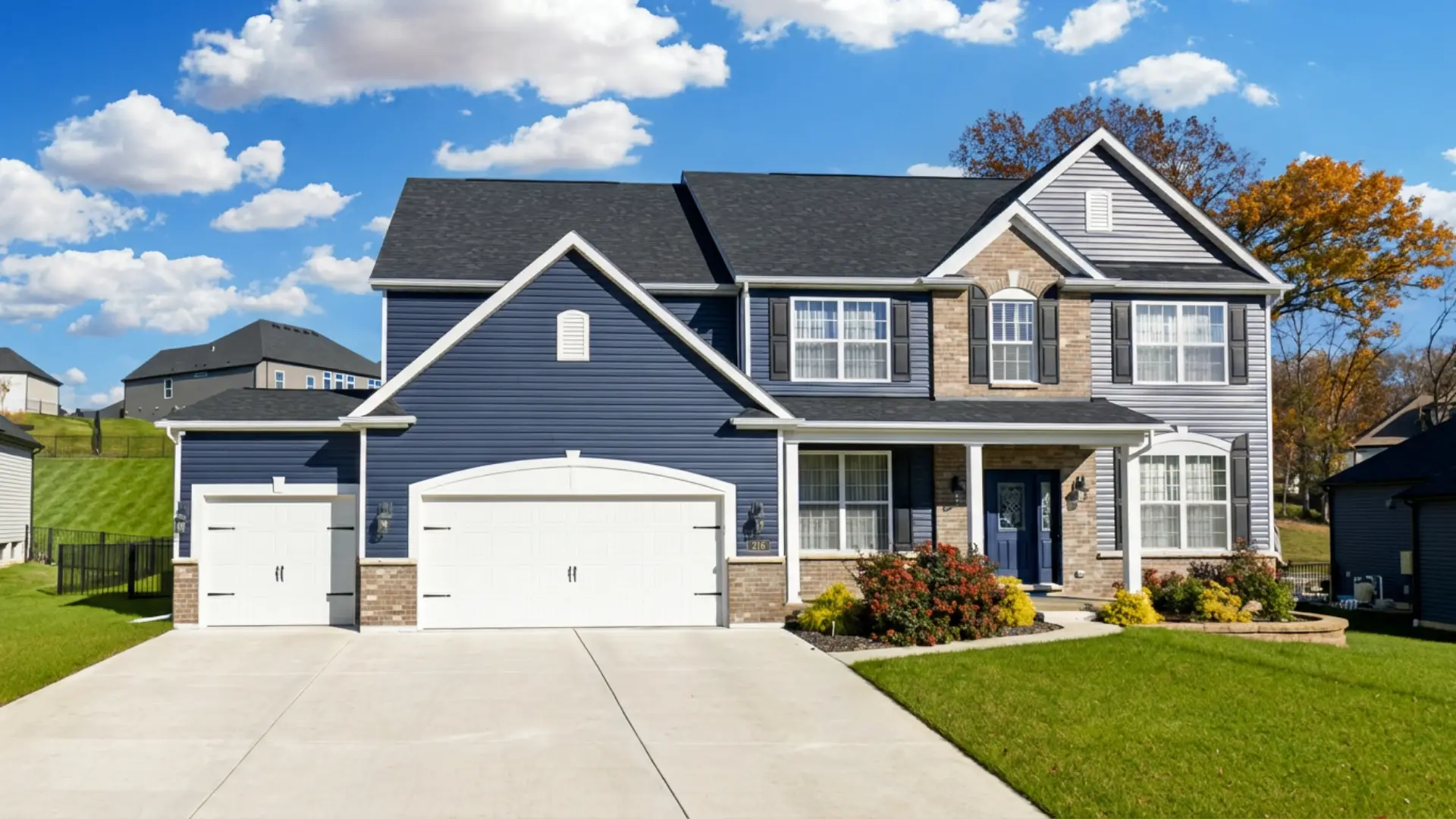 216 Everett Creek Court, O'Fallon, MO — navy two-story home with brick and three-car garage.