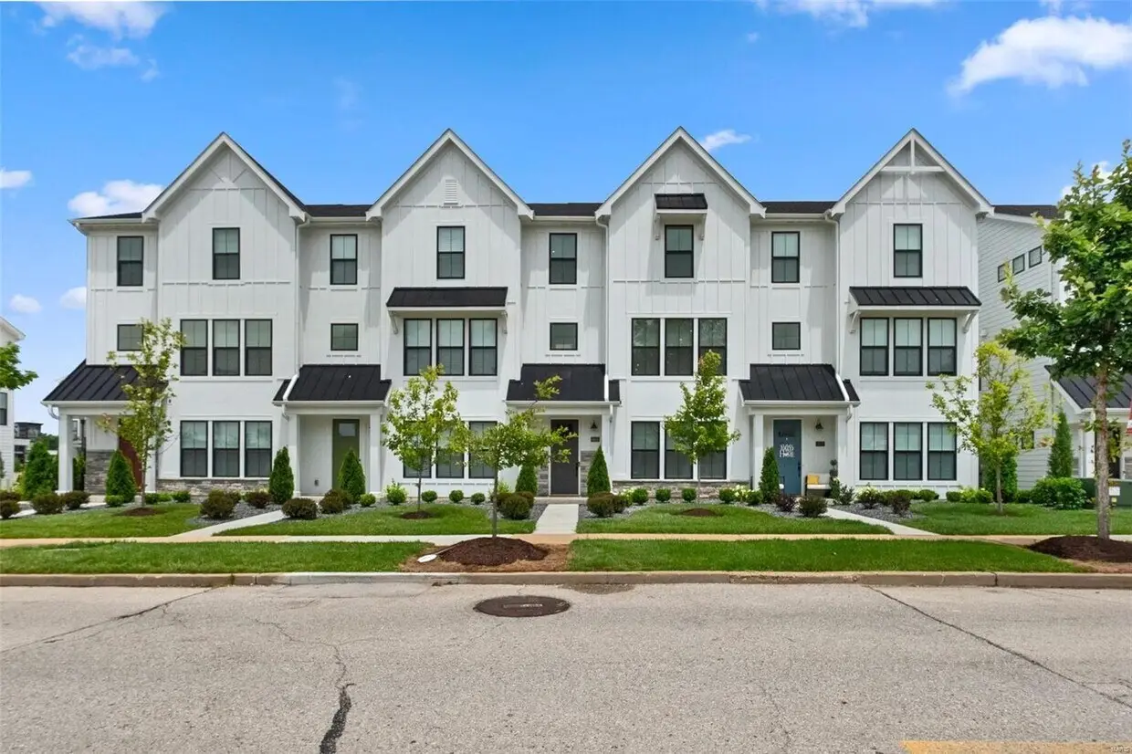 8933 Eager Road — modern white farmhouse-style townhomes.